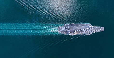 Nuclear ship warship Military navy ship carrier full loading fighter jet aircraft and Helicopters sailing in the ocean. Military warship deck loaded with fighter jets Naval defense power army force