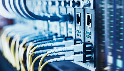 Fiber Optical cables connected to an optic ports and Network cables connected to ethernet ports