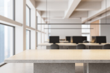 Modern office interior with blurred background and stone counter in foreground emphasizing open workspace design and natural lighting concept. 3D Rendering