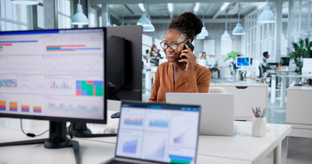 Smiling African Businesswomen Talking To Clients On Phone
