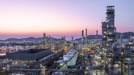 Aerial view oil and gas petrochemical storage tank with oil and gas refinery plant at twilight, Global business power and energy petrochemical industry, Oil and gas refinery petrochemical industrial.