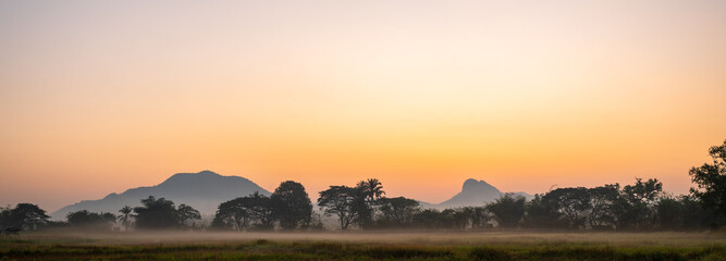 Beautiful natural panoramic countryside landscape with mountains at sunset. Rainforest ecosystem and healthy environment concept background. Nature background.