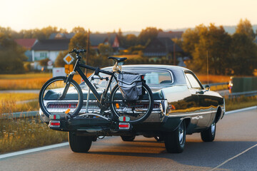 Bicycle secured to back of classic vehicle