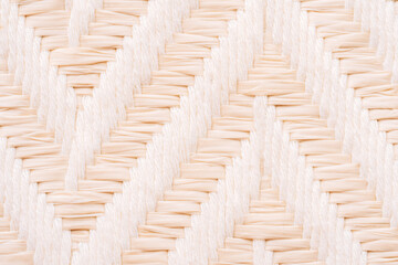 Light beige woven texture background, natural fabric pattern close up with copy space.