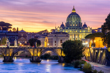 St. Peter's basilica dome in Vatican and St. Angel bridge over Tiber river at sunset in Rome, Italy