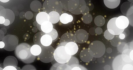 Glowing abstract bokeh lights creating soft dreamy backdrop in dark field, with golden sparkles