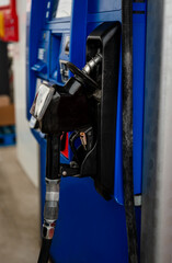 Close up of fuel nozzle on a gas pump at the gas station.