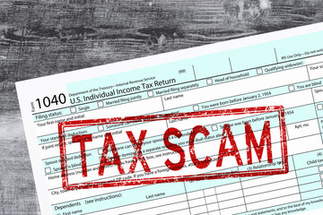 Tax scam warning on 1040 tax form concept