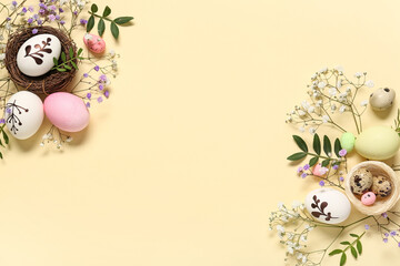Easter eggs with beautiful gypsophila flowers and leaves on beige background