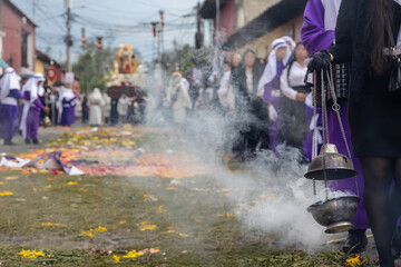 Incense burner with smoke during Semana Santa procession in Antigua Guatemala, traditional Holy Week street scene with cultural atmosphere and selective focus