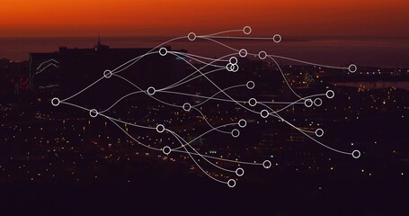 Tracing network overlay moving across coastal skyline at sunset with lit windows and pier lights