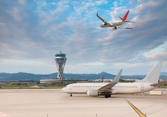 White Passenger plane fly up over take-off runway from airport - El Prat-Barcelona airport. This airport was inaugurated in 1963 - Barcelona, Spain