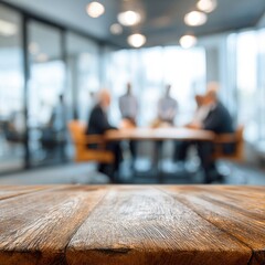A group of people meets in a modern office setting to talk and collaborate on projects at a wooden table during the day