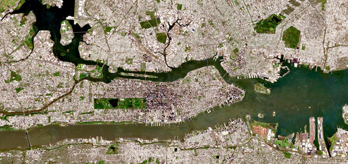 Aerial satellite view of New York City, Manhattan and surrounding boroughs with visible urban grid, rivers, bridges and coastal landscape in the USA