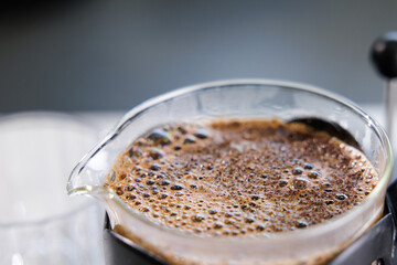 Macro closeup of coffee crema bubbles and texture on french press surface
