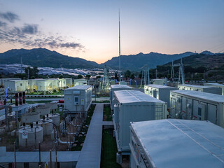Energy storage power station at dusk located in mountainous area with full view of facilities and landscape