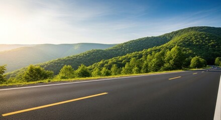 Empty asphalt highway road stretching through a lush green mountain forest landscape under a bright blue sky on a sunny summer day