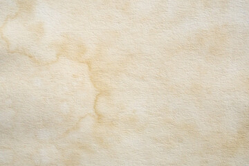 Old vintage paper texture background with aged stains and antique yellowed parchment effect