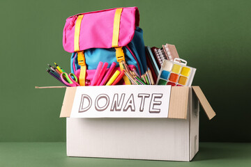Box of school supplies for donation with backpack and art materials
