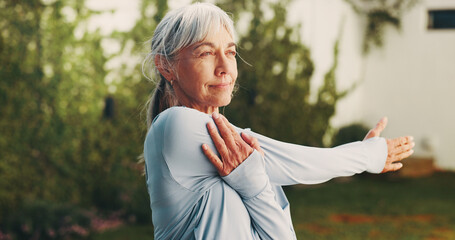 Backyard, wellness and senior woman stretching for functional fitness, shoulder mobility or exercise. Active, pensioner or arm warm up at house for retirement health, physical activity or flexibility
