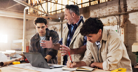 Carpentry, team and laptop in warehouse for planning, project management and help for apprentice. Men, tech and discussion in woodworking factory for collaboration, tips and productivity with agenda