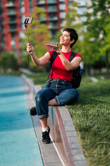 Woman creating social media content with smartphone outdoors