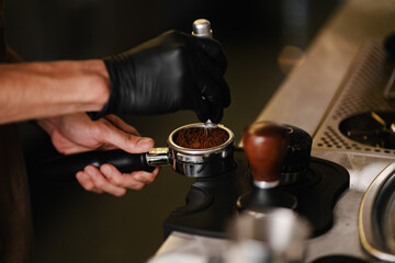 Professional Barista Preparing Fresh Espresso Using Portafilter in Modern Coffee Shop 