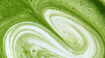 a frothy matcha latte, known for its distinctive emerald hue and subtle swirls of creamy foam, captured in both macro and wide-angle shots, featuring a detailed texture close-up and viewed from the to