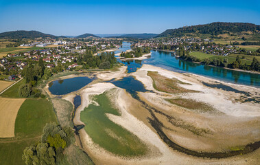 Historical record of low water on the Lower Rhine river with view of Islet Werd and city Stein am Rhein from drone view, due to continueous heat and drought in Summer 2026.