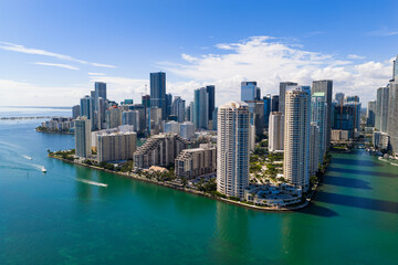 Miami Brickell skyline with skyscrapers along bay. Miami aerial cityscape with skyline. Miami coastal skyline with shoreline. Miami downtown skyline with towers.