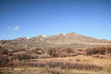 Snow-Dusted Mountains Rise Above Rural Town Outskirts, Nevada