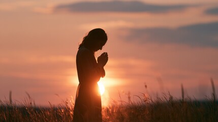 Humble Moment of Prayer: Female Silhouette in Serene Outdoor Scenery